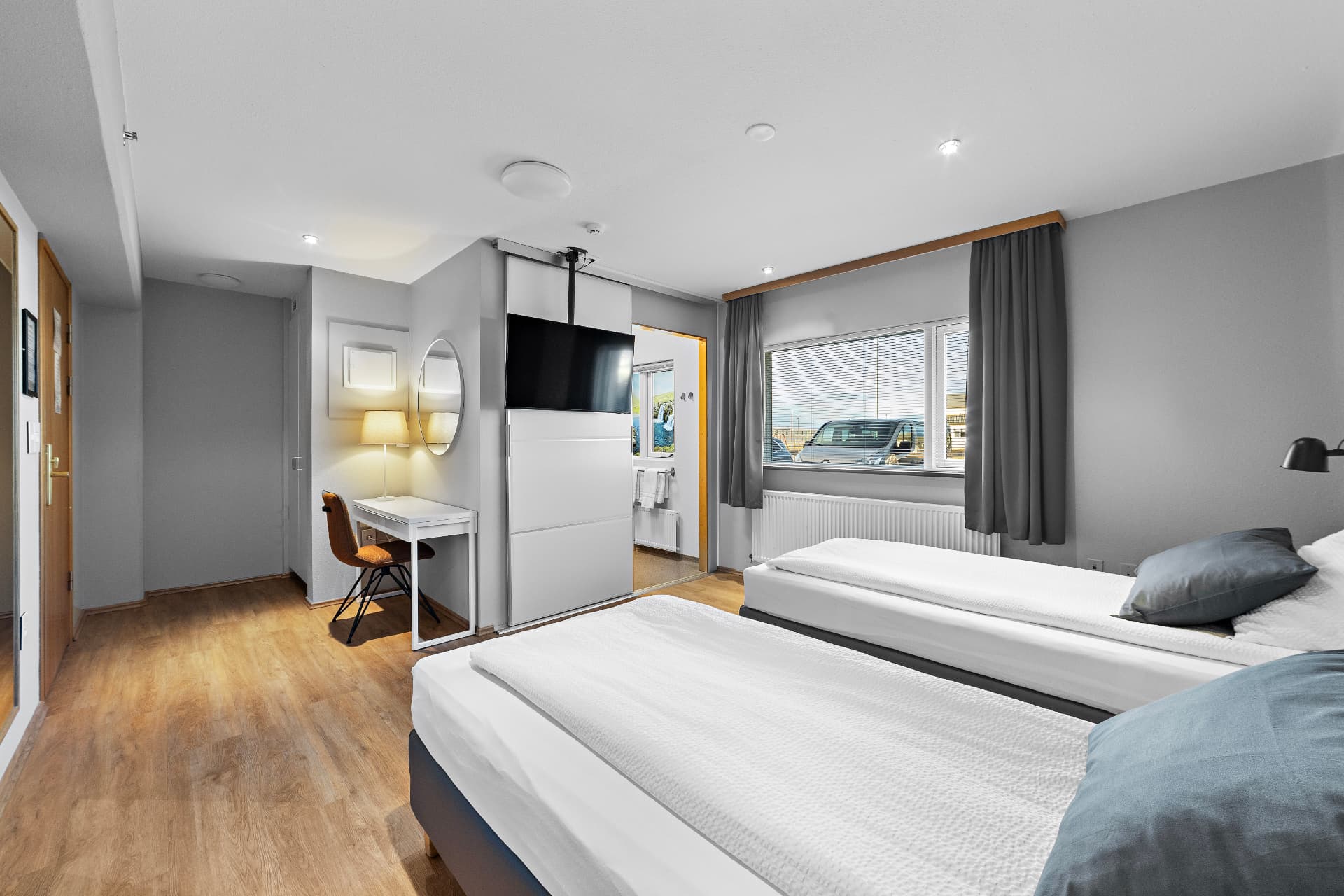 Twin room with private bathroom — beds, desk, TV and wardrobe at START Hostel