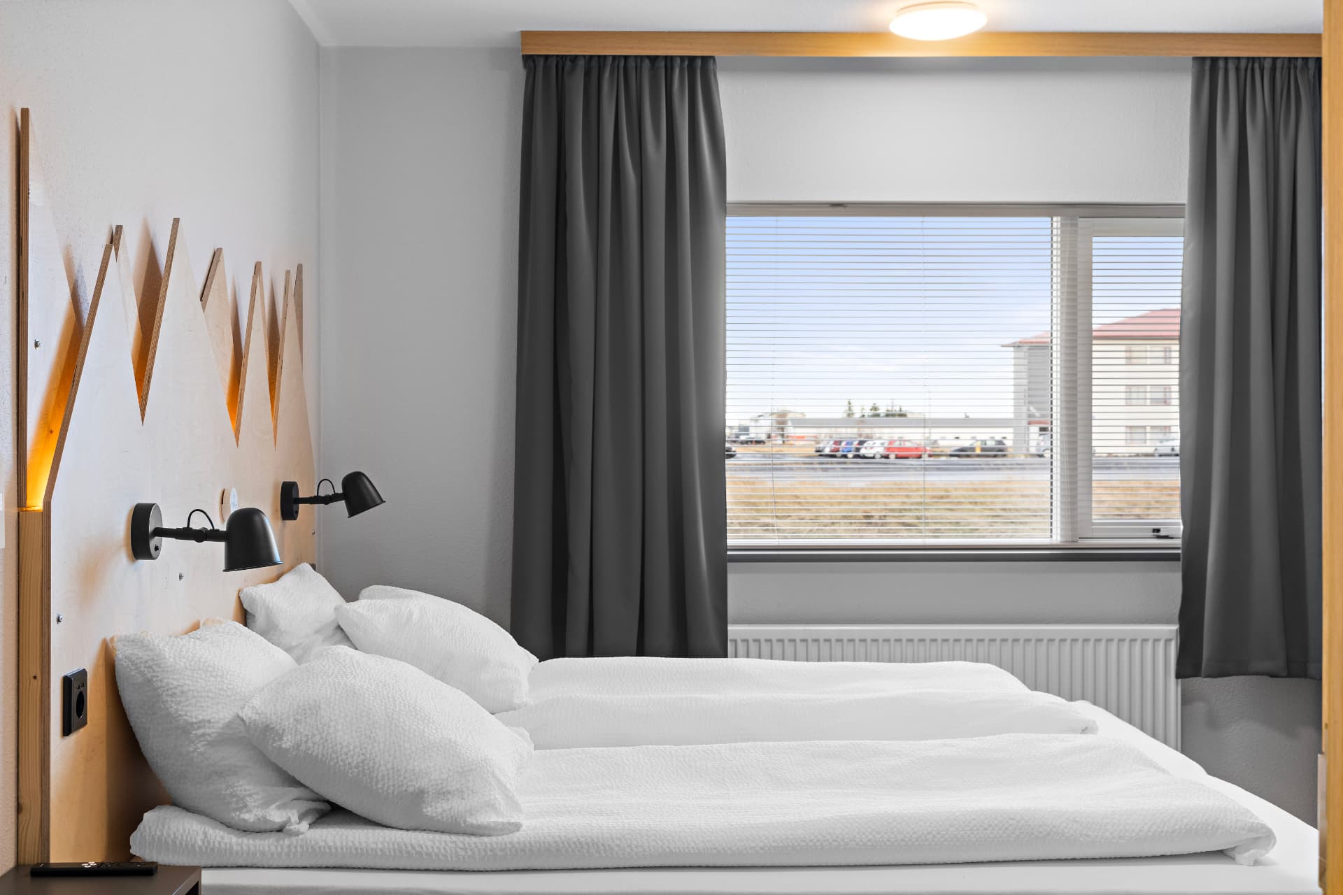 Twin room with shared bathroom — two beds with fresh white linen and reading lights at START Hostel