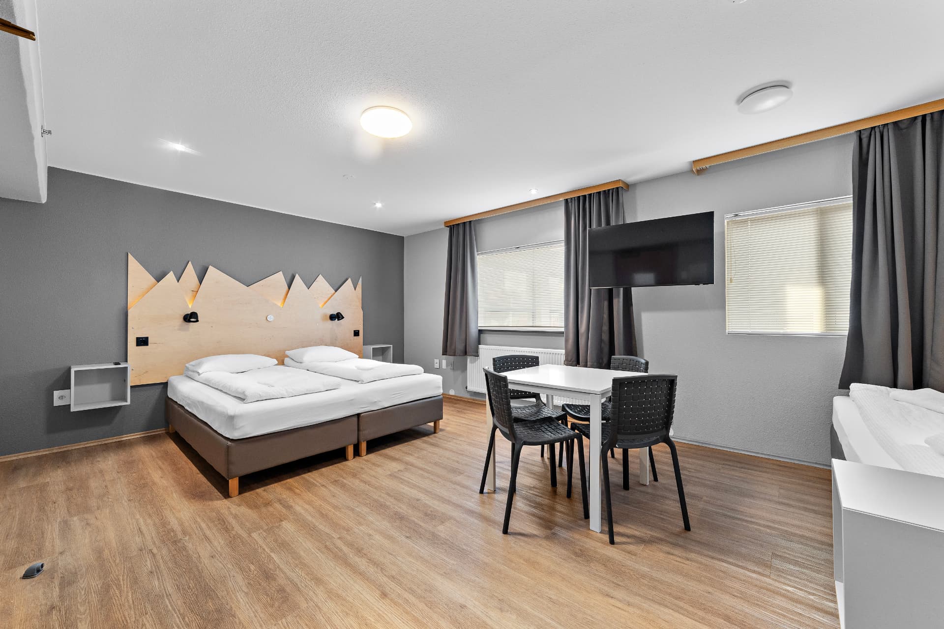 Triple room with shared bathroom — twin beds, dining table and modern TV at START Hostel
