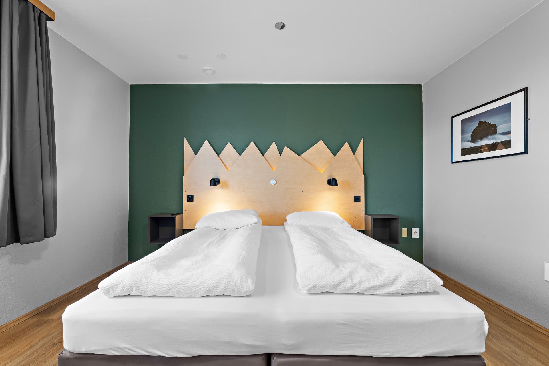 A bright twin room at START Hostel with white linen and reading lights